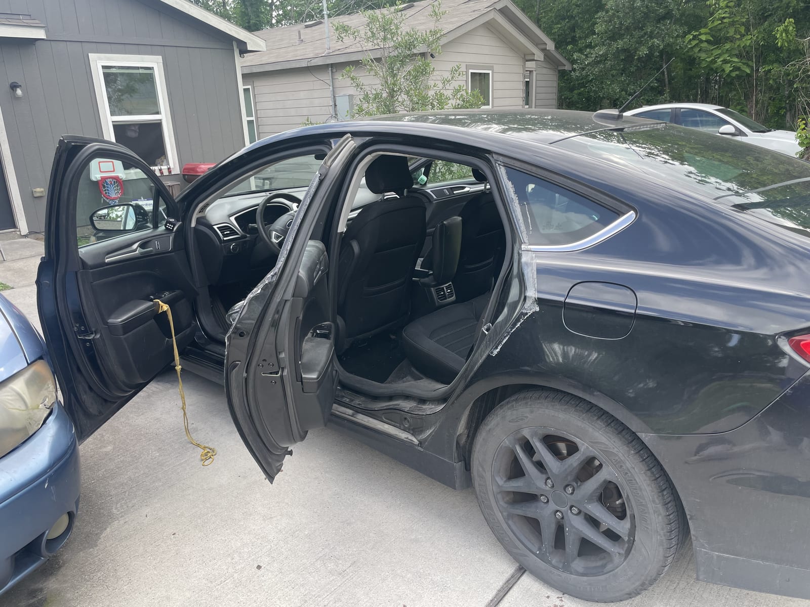 Black sedan before detailing — dull and dirty
